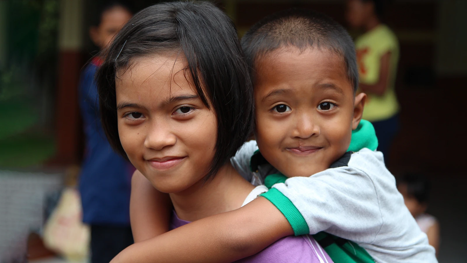 Rifky riding on his sister’s back in Jakarta, Indonesia, hours before the accident described in this article.
